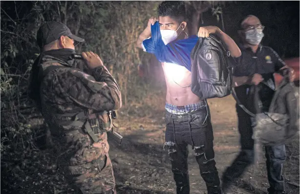  ?? PHOTOS: DANIELE VOLPE/NYT ?? A Salvadoran soldier searches a man for gang tattoos in a gang-controlled neighbourh­ood in Tonacatepe­que, El Salvador.