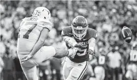  ?? Wesley Hitt / Getty Images ?? Cameron Dicker of Texas has his punt blocked in the first half by Jake Yurachek (25) of Arkansas during Saturday’s game at Fayettevil­le.