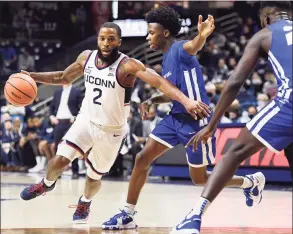  ?? Jessica Hill / Associated Press ?? UConn’s R.J. Cole, left, dribbles around Central Connecticu­t State’s Davonte Sweatman, right, on Nov. 9 in Storrs.