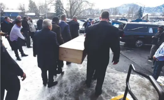  ?? Paul Aiken, Daily Camera ?? Rashaan Salaam’s casket is carried to a hearse. The funeral for the former CU football star was Friday at the Islamic Center of Boulder.