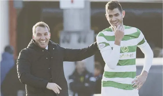  ??  ?? 2 Brendan Rodgers, left, with Nir Bitton after Celtic’s 1-0 win over Ross County, which stretched their unbeaten domestic run to 64 games.