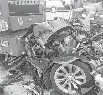  ?? South Jordan Police Department via Associated Press ?? This Tesla Model S sedan crashed last week into a fire department mechanic truck stopped at a red light in South Jordan, Utah.