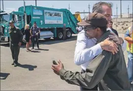  ?? Mel Melcon Los Angeles Times ?? L.A. MAYOR Eric Garcetti hugs maintenanc­e worker Michael Moss after announcing a plan to overhaul the city’s approach to serving homeless people.