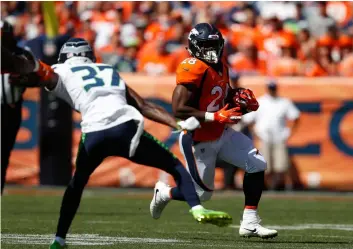  ?? AP PHoto/DAVID ZAlubowSkI ?? Denver Broncos running back Royce Freeman runs with the ball during the first half of an NFL football game against the Seattle Seahawks on Sunday in Denver.