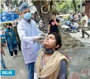  ?? PTI ?? DELHI
A health worker collects swab sample from a woman for Covid-19 test at MCD dispensary in Jangpura. —