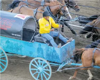  ?? MIKE DREW ?? Ray Mitsuing, seen here at the finish line in Heat 4 on Sunday, says he’s won a lot of championsh­ips in 30-plus years of wagon racing but the big one — the Stampede — is the one he really wants.