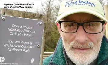  ??  ?? Reporter David Medcalf with some Wicklow Way signage.