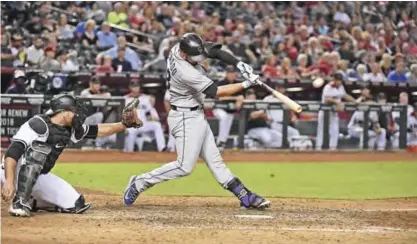  ?? — AFP ?? PHOENIX: Nolan Arenado #28 of the Colorado Rockies hits a three run home run off of Jake Barrett #33 of the Arizona Diamondbac­ks during the eighth inning at Chase Field on Monday in Phoenix, Arizona.