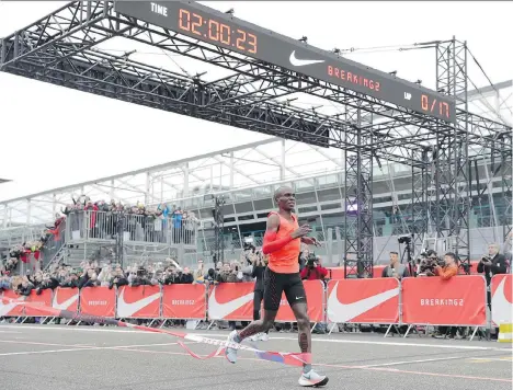  ?? LUCA BRUNO/THE ASSOCIATED PRESS ?? Olympic marathon champion Eliud Kipchoge crosses the finish line at the Monza Formula One racetrack in Italy earlier this month with a time of two hours and 25 seconds. Nike is leading a push for a two-hour marathon.