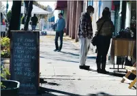  ??  ?? Shoppers walk through downtown Vallejo on Small Business Saturday.