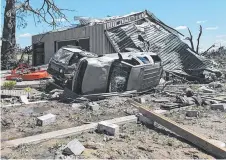  ?? WRECKED: Destroyed vehicles are surrounded by debris in Canton, Texas after tornadoes hit the area. ??