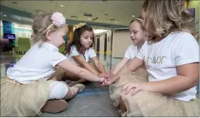  ?? (ALLYN DIVITO/JOHN HOPKINS ALL CHILDREN’S HOSPITAL VIA AP) ?? In this photo provided by Johns Hopkins All Children’s Hospital, Lauren Glynn, Chloe Grimes, McKinley Moore and Avalynn Luciano place their hands together at the hospital in St. Petersburg, Fla., Aug. 9, 2018.