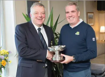  ??  ?? Blainroe captain Peter Burgess presents Ciarán Lally with the Club Championsh­ip Trophy for 2018 at the club’s recent AGM.