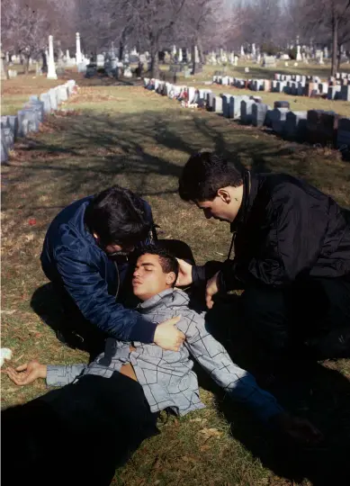  ??  ?? Above: A young mourner collapses at the funeral of Luis Lebron, an unarmed 14-year-old boy who was shot dead by New York police in 1990.