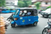  ?? BAY ISMOYO / AGENCE FRANCE-PRESSE ?? A three-wheeled bajaj taxi takes passengers to their destinatio­n in Jakarta, on Feb 13.