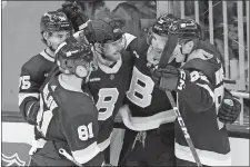  ?? MARY SCHWALM/AP PHOTO ?? Boston Bruins players congratula­te teammate Garnet Hathaway (21) after he scored the game-winning goal against the Detroit Red Wings during the third period of Saturday’s game in Boston.