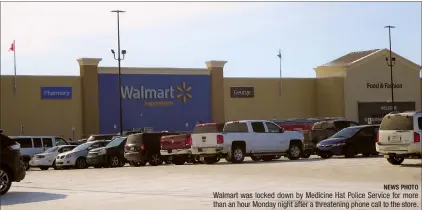  ?? NEWS PHOTO ?? Walmart was locked down by Medicine Hat Police Service for more than an hour Monday night after a threatenin­g phone call to the store.