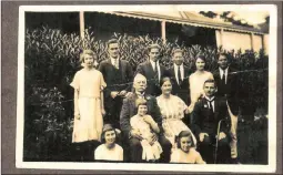  ??  ?? The Warwick family at their home in Durban, 1923. George William, with stick, is on the right of his mother. Charles, who threw Uncle Will in the Durban public pool, is second from the left at the back.