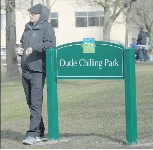  ?? NICK PROCAYLO/PNG ?? Jonny Schmidtgal­l chills out Thursday at the newly installed Dude Chilling Park sign in Vancouver’s Guelph Park.