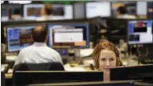  ?? MARK LENNIHAN — THE ASSOCIATED PRESS ?? In this photo, traders work on the Mizuho Americas trading floor in New York. Technology companies are leading stocks slightly higher in early trading on Wall Street, Tuesday.