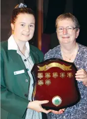  ??  ?? Stephanie Paul receives the perpetual community service award shield from Dorothy Hoare.