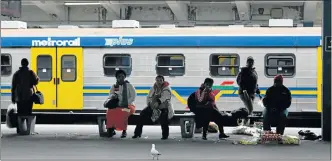  ??  ?? LONG WAIT: Commuters wait in vain for a Metrorail train service in Cape Town during a strike by train workers