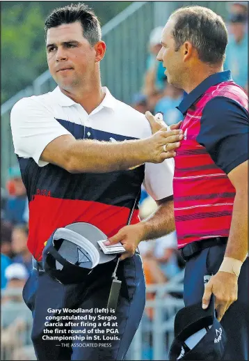  ?? — THE ASSOCIATED PRESS ?? Gary Woodland (left) is congratula­ted by Sergio Garcia after firing a 64 at the first round of the PGA Championsh­ip in St. Louis.