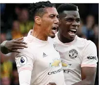  ??  ?? PRETTY IN PINK: Smalling celebrates with midfield maestro Paul Pogba after blasting in United’s second goal