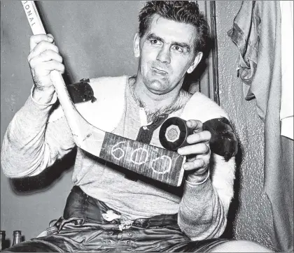  ?? CP PHOTO ?? In this Nov. 26, 1958, file photo, Montreal Canadiens’ Maurice (Rocket) Richard poses with his hockey stick marked 600 and a puck after scoring his 600th career goal in an NHL game against New York Rangers in New York.