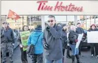  ?? CP PHOTO ?? President of Ontario Federation of Labour Chris Buckley joins protesters outside a Tim Hortons Franchise in Toronto on Wednesday. Labour organizati­ons across Ontario are holding rallies today to protest the actions some Tim Hortons franchises have...