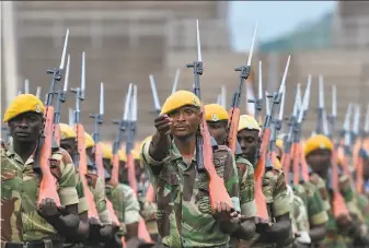  ?? Tony Karumba / AFP / Getty Images ?? Soldiers march in formation during drills to prepare for Friday’s inaugurati­on of incoming President Emmerson Mnangagwa at the national stadium in Harare, Zimbabwe’s capital.