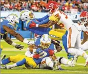  ?? Robert Gauthier Los Angeles Times ?? CHARGERS running back Austin Ekeler is stopped for a short gain in Sunday’s 30-27 loss to the Chiefs.