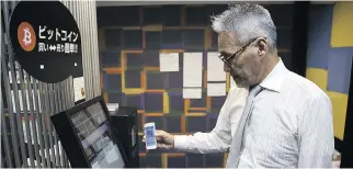  ??  ?? An employee uses a smartphone during a demonstrat­ion of buying bitcoin from an ATM in Tokyo. Mainstream consumers have yet to use cryptocurr­encies in great numbers, though they have been gaining buzz among investors.