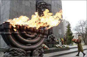  ?? The Associated Press ?? A wreath is laid at the monument to the Heroes of the Warsaw Ghetto in Warsaw, Poland, on Wednesday, as the world observes the 76th anniversar­y of liberation of Nazi death camp.