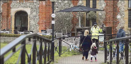  ?? AFP ?? A police officer stands in front of The Mill pub in Salisbury, southern England on Sunday, as investigat­ions continue in connection with the major incident sparked after a man and a woman were apparently poisoned in a nerve agent attack a week ago.