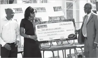  ??  ?? Fortwell Wholesale General Manager, Ms Hanneriett­a Choga, hands over a $6 500 cheque to the Bulawayo Public Library Chairperso­n Mr Joseph Sigola for the braille department at a ceremony held in Bulawayo recently