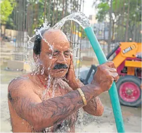  ?? ?? COOL: A worker at a building site seeks respite in Uttar Pradesh.