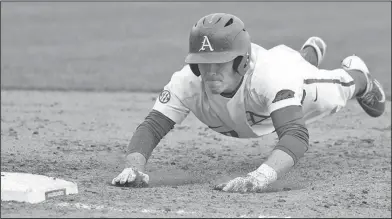  ?? Craven Whitlow/Special to the News-Times ?? Back to the bag: Arkansas' Carson Shaddy dives back to first base during a game against Bucknell in Fayettevil­le earlier this month. Arkansas begins a five-game homestand today against Dayton.