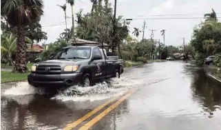  ?? JOEY FLECHAS Miami Herald Staff | File, Oct. 5, 2017 ?? A king tide brought high waters to low-lying streets on Normandy Isle in 2017. New research shows that lower-elevation single-family homes now gain value slower than their higher elevation peers.