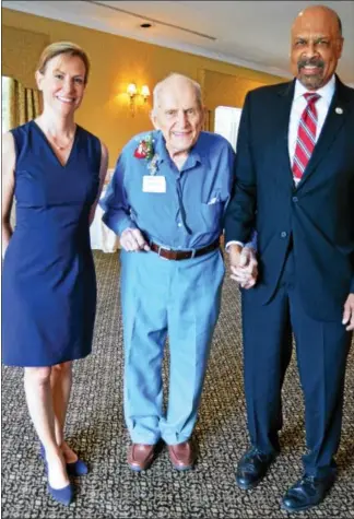  ?? SUBMITTED PHOTO ?? Joseph Dugan, 101, poses for a photo with county Commission­ers Michelle Kichline and Terence Farrell, at the sixth annual Centenaria­n Birthday Party at the Penn Oaks Country Club hosted by the Chester County Department of Aging Services.