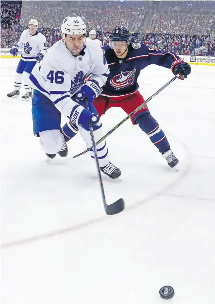  ?? KIRK IRWIN / GETTY IMAGES ?? Roman Polak of the Leafs and Artemi Panarin of the Blue Jackets chase a loose puck Wednesday night.