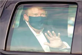  ?? AFP ?? A car with US President Trump drives past supporters in a motorcade outside of Walter Reed Medical Center in Bethesda, Maryland on Sunday.