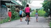  ??  ?? CHILDREN play outside the home of Pornchai Khamluang, one of the trapped boys. His parents are members of a minority group and he is stateless.