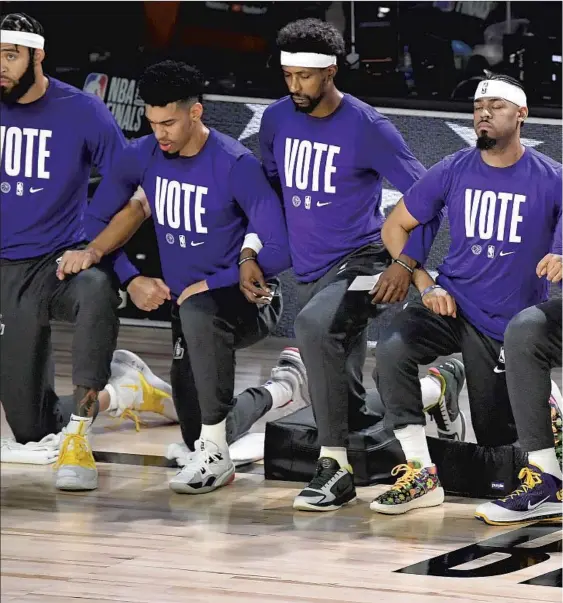  ??  ?? LAKERS PLAYERS and coach Frank Vogel made a statement of solidarity and protest against racial injustice before the start of the NBA Finals on Sept. 30. Weeks earlier,