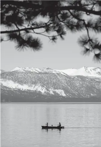  ??  ?? A couple paddles past Kings Beach in North Lake Tahoe, California. In the early 1860s, Mark Twain hiked to North Lake Tahoe with a friend. He wrote about paddling on the lake and accidental­ly starting a forest fire.