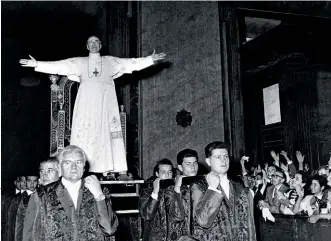  ??  ?? COMPLICIT? Possible sainthood for Pius XII (at right) blessing pilgrims at the Vatican, has been stalled by his image as “Hitler’s Pope.”