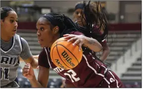  ?? More photos at arkansason­line.com/1124ualr/.
(Arkansas Democrat-Gazette/Thomas Metthe) ?? UALR guard Tia Harvey (12) drives to the basket Wednesday while guarded by Oral Roberts guard Ariel Walker during the Trojans’ 74-62 loss at the Jack Stephens Center in Little Rock.