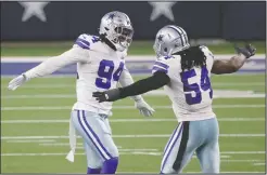  ?? The Associated Press ?? NOT DONE YET: Dallas Cowboys defensive end Randy Gregory (94) and Jaylon Smith (54) celebrate after Gregory sacked Philadelph­ia Eagles’ Jalen Hurts in the second half of Sunday’s game in Arlington, Texas.