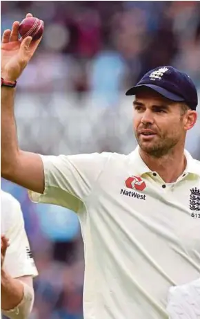  ?? AFP PIC ?? England’s James Anderson holds up the ball after taking his fifth wicket of the inning against South Africa yesterday.