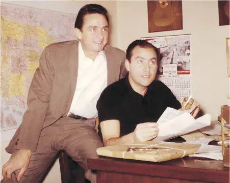  ??  ?? Johnny Cash and Saul Holiff in the Ventura, California-based offices of Johnny Cash Incorporat­ed in 1961.